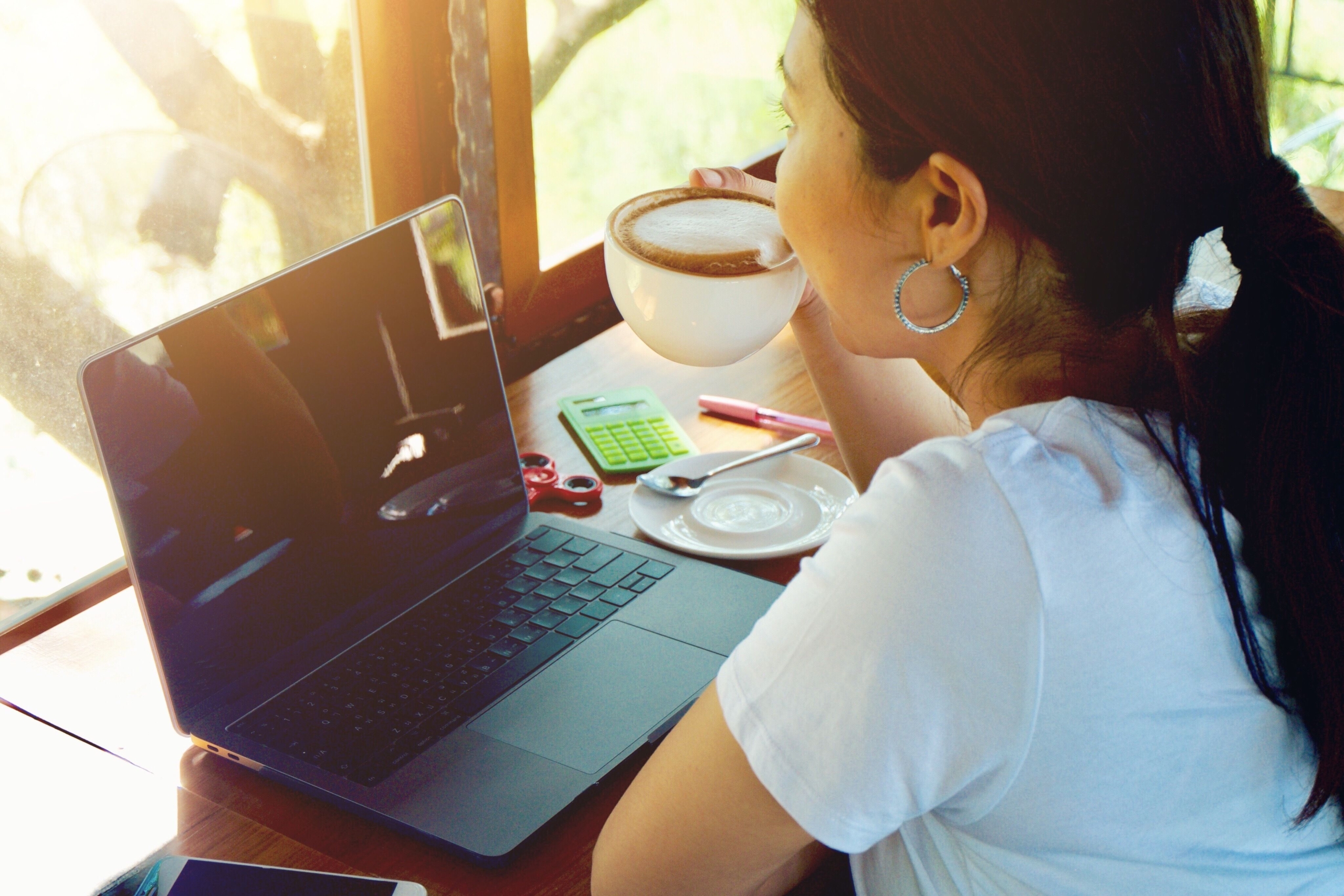 woman working and drinking coffee